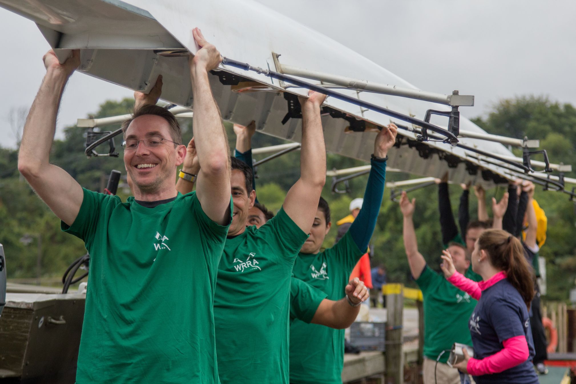 team carrying boat together